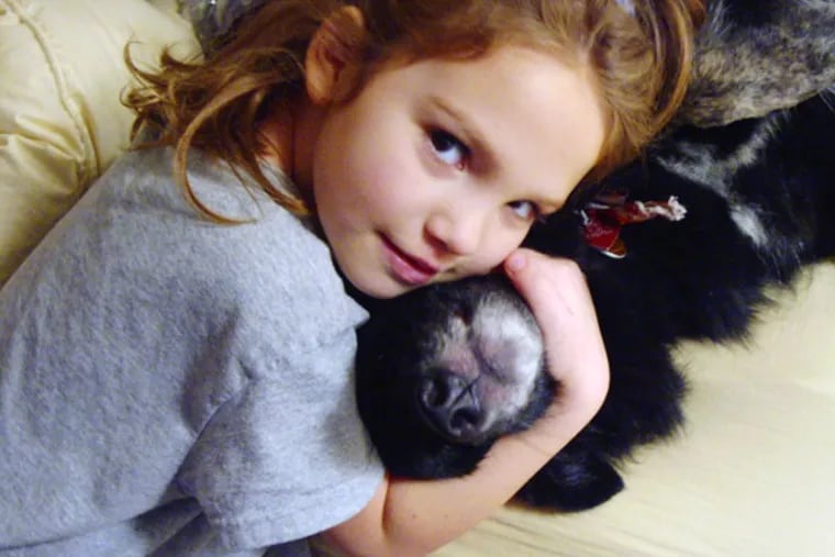 Blackie in 2001, being shown the love by my daughter, Addie, then 5.