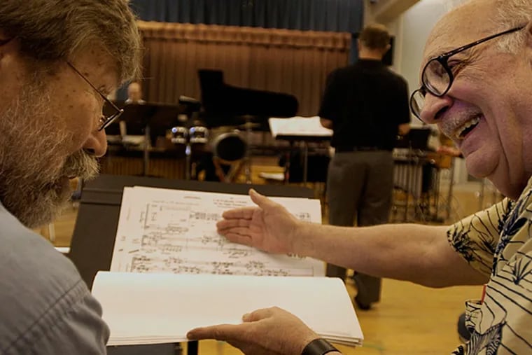 Composer George Crumb (right) talks about his composition, The Winds of Destiny, with friend and composer Andrew Roudin (left) during Orchestra 2001's rehearsal at the Settlement Music School Wed. Photo:  RAY M. JONES)