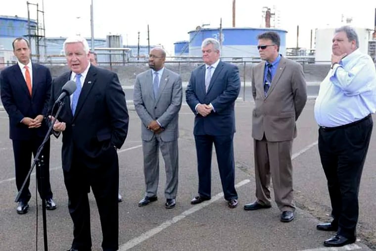 FILE - On July 2, 2012, then-Gov. Tom Corbett (front) spoke at a news conference outside Sunoco's Philadelphia refinery on Passyunk Avenue. Behind him were (from left) David Marchick, managing director, the Carlyle Group; then-Mayor Michael Nutter; then-U.S. Rep. Bob Brady;  Jim Savage, Local 10-1, United Steelworkers (he represents the 600 union workers at this plant); and Tom Conway, international vice president, United Steelworkers Union. (TOM GRALISH / Staff Photographer)