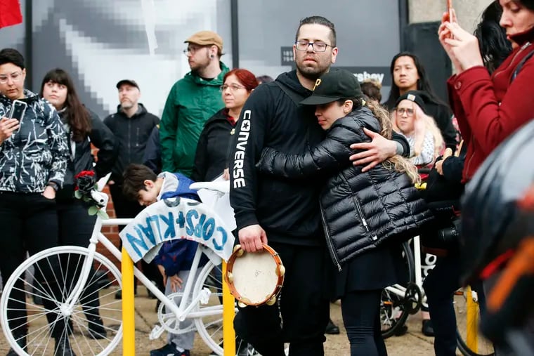 Bryan Avendano (center with tambourine), brother of killed bicyclist Pablo Avendano, is comforted during a Ghost Bike memorial on Spring Garden Street in May 2018. He was killed while working for a food delivery service.