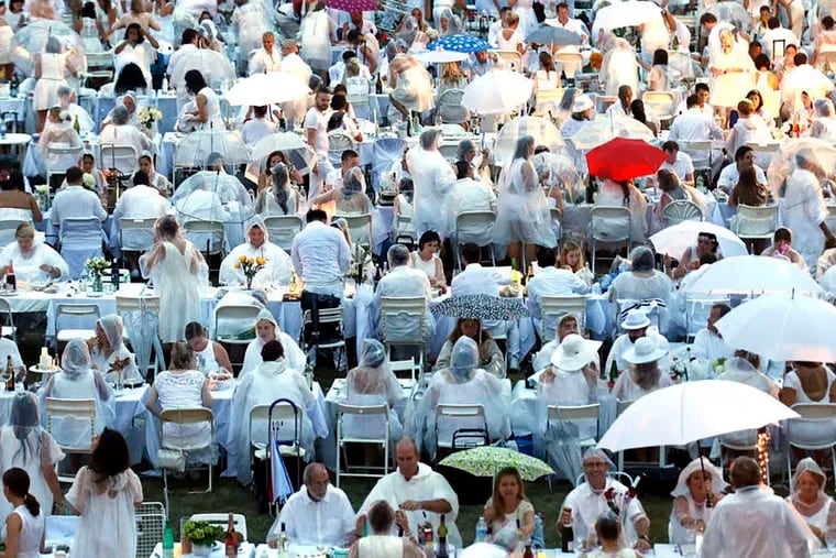 Guests, all clad in white, pop-up in a secret space for the fourth annual Diner en Blanc in 2015 at the Navy Yard in South Philadelphia.