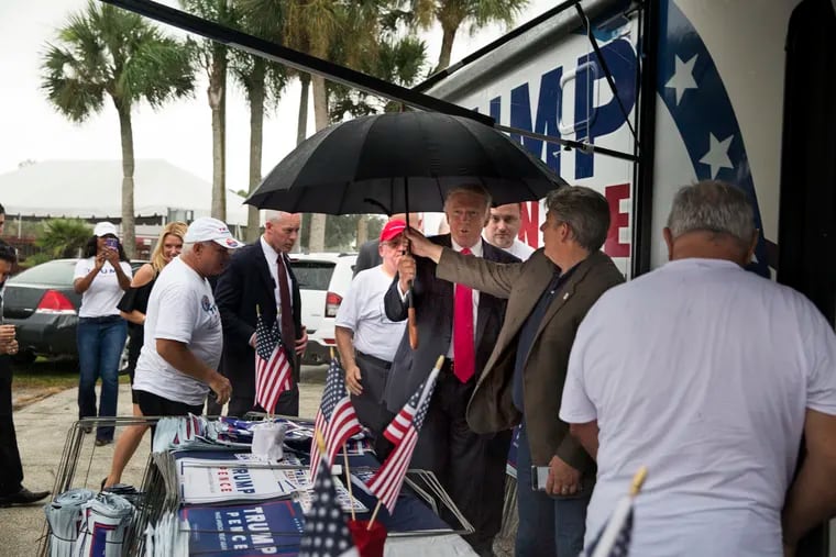 FILE - In an Aug. 24, 2016, file photo, then-Republican presidential nominee Donald Trump meets supporters organizing voter registration and support for his campaign just before a rally at the Florida State Fairgrounds in Tampa, Fla. A federal lawsuit alleging Trump kissed a former campaign staffer during the rally was dismissed, Friday, June 14, 2019. (Loren Elliott / Tampa Bay Times via AP, File)