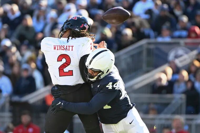 Penn State defensive end Chop Robinson (44) forces a fumble by Rutgers quarterback Gavin Wimsatt. Robinson recently met with the Eagles ahead of the NFL draft.