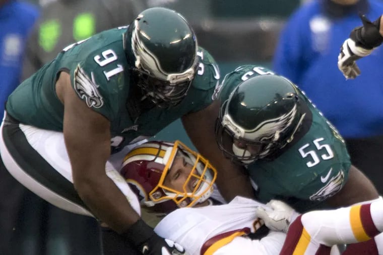 Eagles Fletcher Cox (left) and Brandon Graham sack Redskins quarterback Kirk Cousins in the 3rd quarter of the game at Lincoln Financial Field December 11, 2016. The Redskins won the game 27-22.