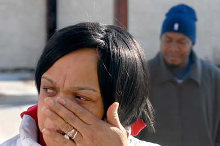Brushing aside a tear, Diana Seidle mourned two friends inexplicably shot to death Saturday in Grays Ferry. (Tom Gralish / Staff Photographer)