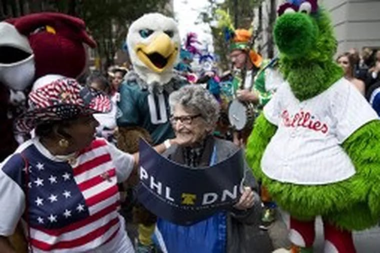 In a 2014 photo, Pearl Carpel, center, and Yvonne Cobb, left, wait with Philadelphia sports mascots to greet Democratic National Committee representatives, who were considering where to hold their 2016 convention. Ms. Carpel was a regular at public events in Philadelphia.  MATT ROURKE / AP FILE PHOTO