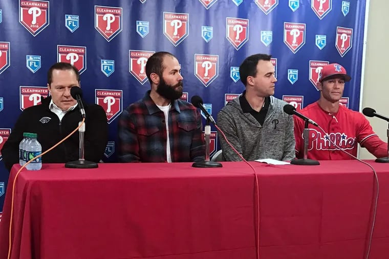 Phillies pitcher Jake Arrieta (second from left) has faith in Matt Klentak (center) to make a deal at the deadline to help the team make the playoffs.