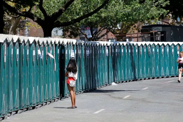 Attendees wait to use portable toilets at the Made In America festival in 2015.