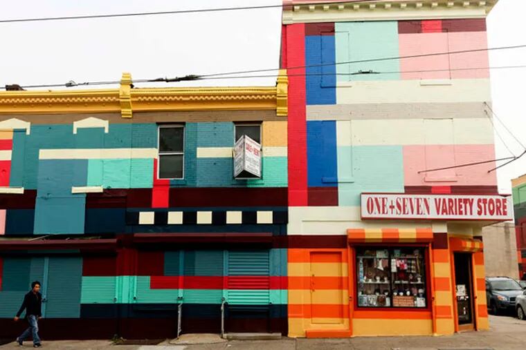 Haas & Hahn's "Philly Painting" is stripes along two blocks of Germantown Avenue in North Philadelphia. The city says it will provide regular street cleaning, new sidewalks and lighting.
