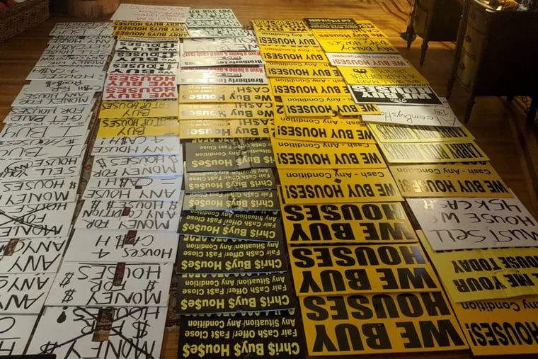 Some of the 200+ ‘bandit signs’ Michael Froehlich collected after offering neighbors $1 per sign. The city is launching its own bounty program.