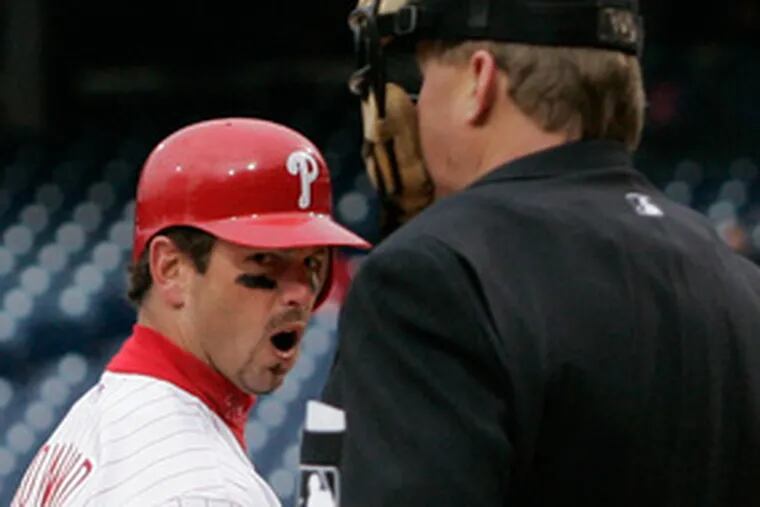 The Phillies&#0039; Aaron Rowand has words for umpire Bill Miller after Miller caled Rowand out on strikes with the bases loaded in the ninth inning. The Phils were 3 for 17 with runners in scoring position.
