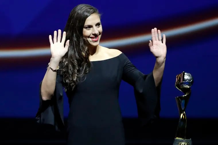 Delran native Carli Lloyd brought the women's World Cup trophy on stage before the United States women's national soccer team found out which opponents they'll face at next year's tournament in France.