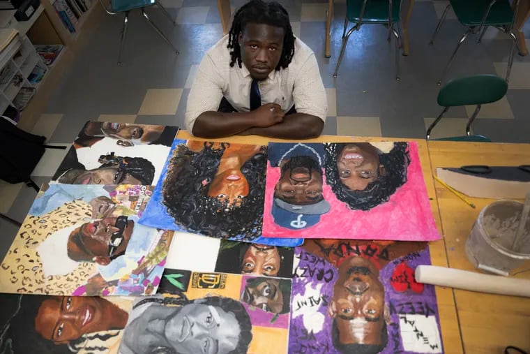 Ivan Bailey-Greene, a defensive tackle at St. Joseph's Prep, is photographed with his paintings on May 7.