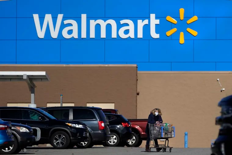 A woman wheels a cart with her purchases out of a Walmart, on Nov. 18, 2020, in Derry, N.H. Walmart, the nation’s largest employer, is expanding its abortion coverage for employees, according to a memo sent to employees Friday, Aug. 19, 2022, after staying mum on the topic for months following the Supreme Court ruling that scrapped a nationwide right to abortion.