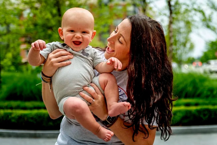 Leigh Ronnan poses with her 8 month-old son Barnett Brady outside their King of Prussia home.