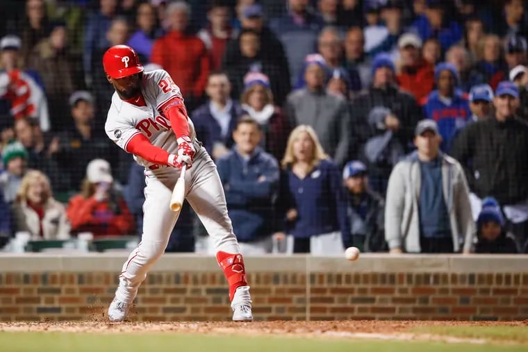 Philadelphia Phillies' Andrew McCutchen hits a two-RBI single against the Chicago Cubs during the seventh inning of a baseball game, Tuesday, May 21, 2019, in Chicago. (AP Photo/Kamil Krzaczynski)