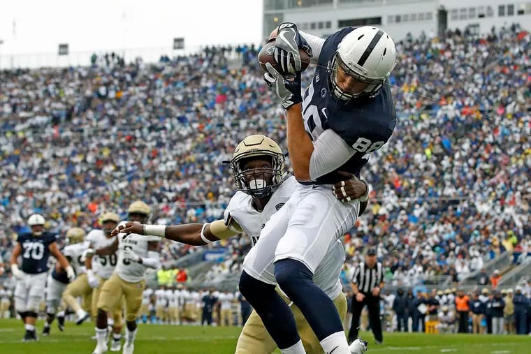 Penn State's Mike Gesicki (88) catches a touchdown pass as Akron's Shawn Featherstone (2) defends during the first half of an NCAA college football game in State College, Pa., Saturday, Sept. 2, 2017.