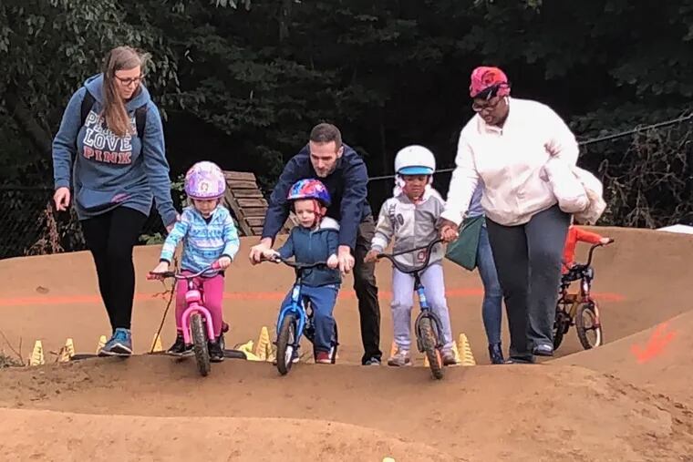At the Philly Pumptrack, parents help their children ride.