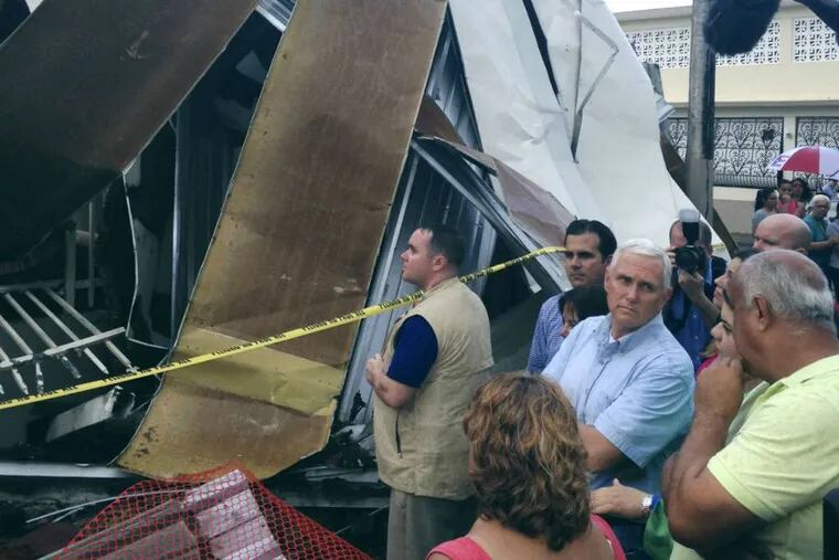 Vice President Mike Pence tours a neighborhood damaged by Hurricane Maria in San Juan, Puerto Rico, on Friday, Oct. 6, 2017.
