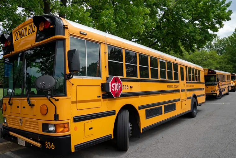 Fairfax County Public School buses parked at a middle school in Falls Church, Va. Very few Americans believe schools should return to normal operations this fall, a new poll says, even as President Donald Trump insists that’s what parents and students want.