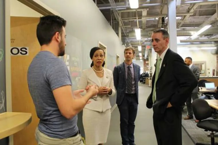 Gathered at NextFab’s “makerspace” in South Philadelphia are (left to right) Alperen Topay, cofounder of motorcycle-headphone company EAOS; U.S. Rep. Lisa Blunt Rochester; Evan Malone, president of NextFab; and U.S. Rep. Brian Fitzpatrick.