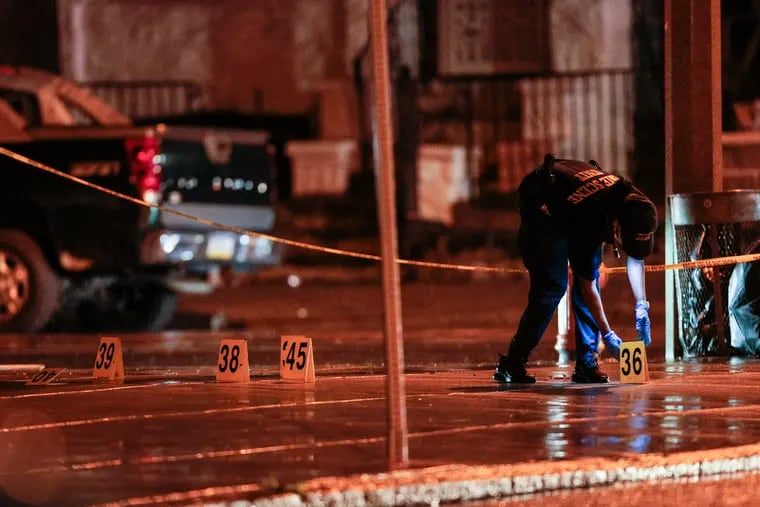 Police on the scene where seven people were shot, five fatally, in Kingsessing on Monday.