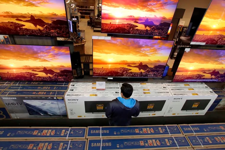 In this Nov. 22, 2018 photo, a man looks at televisions during an early Black Friday sale at a Best Buy store in Overland Park, Kan.  The retailer is one of just six companies in the Standard & Poor's 500-stock index where women make up the majority of board members. (AP Photo/Charlie Riedel, File)