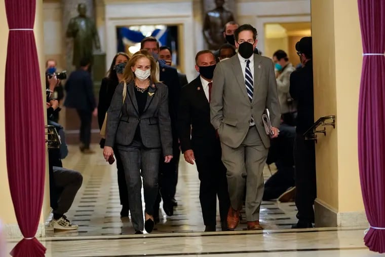 Impeachment managers Rep. Madeleine Dean (D., Pa) and Rep. Jamie Raskin (D., Md.) walk to the House chamber on Capitol Hill in Washington on Wednesday.