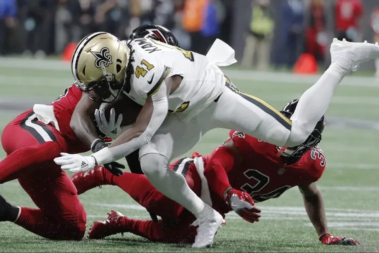 Atlanta Falcons middle linebacker Deion Jones (45) hits New Orleans Saints running back Alvin Kamara (41) during the first half of an NFL football game, Thursday, Dec. 7, 2017, in Atlanta. (AP Photo/David Goldman)