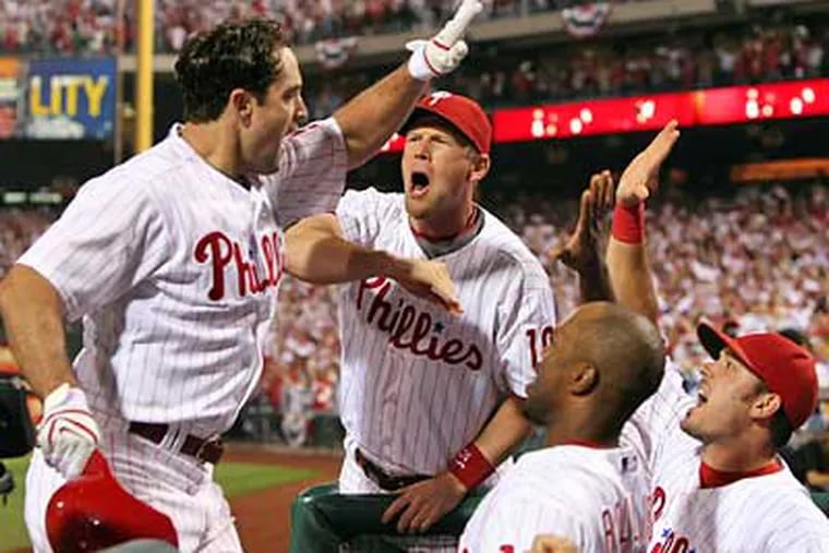 Pat Burrell is greeted by teammates after his go-ahead solo homer in the sixth inning of Game 1 of the NLCS. (Jerry Lodriguss / Staff Photographer)