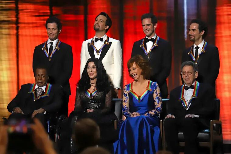 2018 Kennedy Center honorees, front row from left, Wayne Shorter, Cher, Reba McEntire and Philip Glass; while back row from left, the co-creators of "Hamilton," Thomas Kail, Lin-Manuel Miranda, Andy Blankenbuehler and Alex Lacamoire appear on stage during the 41st Annual Kennedy Center Honors at The Kennedy Center, Sunday, Dec. 2, 2018, in Washington. (Photo by Greg Allen/Invision/AP)