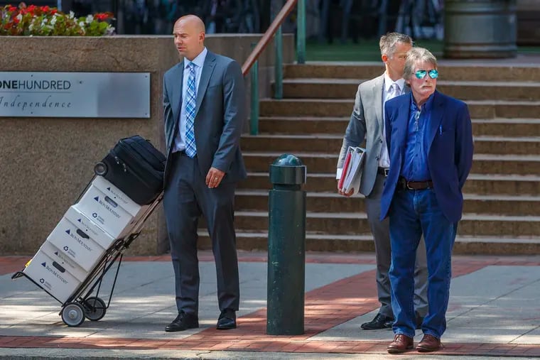 Lloyd Industries CEO Bill Lloyd (right) arrives at the Federal Courthouse with his lawyers, Brandon J. Brigham (left), and Jason Mills for a hearing last month.
