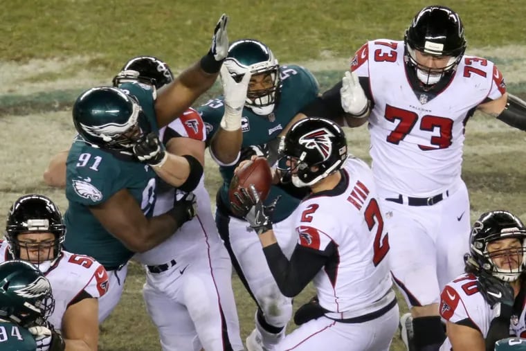 Eagles defensive tackle Fletcher Cox (91) reaches to sack Falcons quarterback Matt Ryan (2) during the first half of the Eagles' playoff game against the Atlanta Falcons at Lincoln Financial Field on Saturday, Jan. 13, 2018. TIM TAI / Staff Photographer