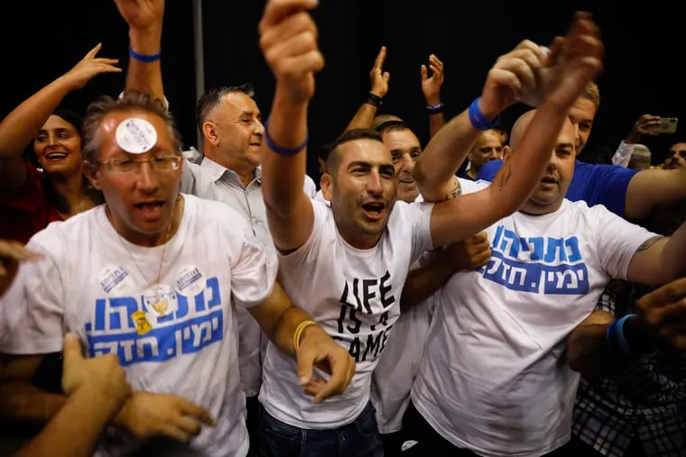 Israeli Prime Minister Benjamin Netanyahu supporters chant as they await results of the elections in Tel Aviv, Israel, Tuesday, Sept. 17, 2019.