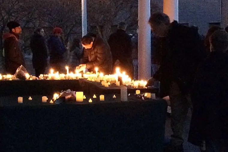 Mourners light candles last night during a vigil for Cayman Naib, found dead after a four-day search. MARI SCHAEFER / STAFF