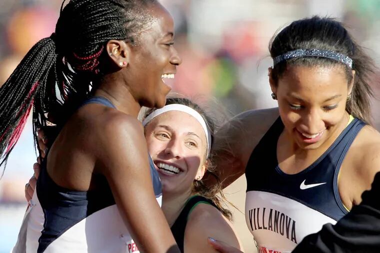 Villanova's Emily Lipari, center, who ran the anchor leg, is hugged by teammates Nicky Akande, right, and Angel Piccirillo as the Villanova won the College Women's  Distance Medley Championship at the Penn Relays on April 25, 2013.  ( CHARLES FOX / Staff Photographer )