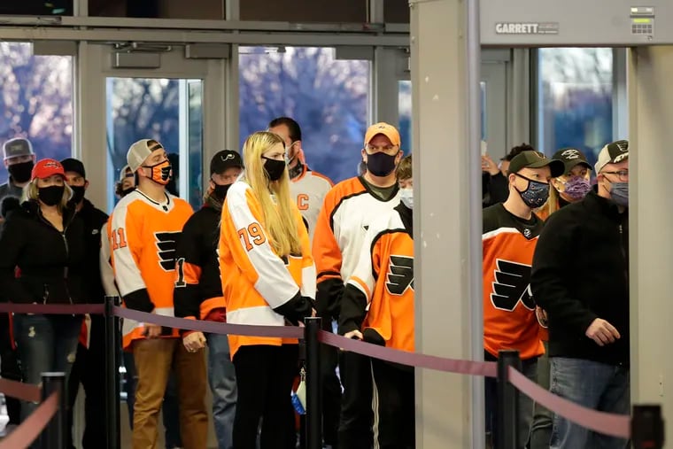 Fans wait in line before entering the Wells Fargo Center for the Flyers and Washington Capitals game on Sunday, March 7, 2021.
