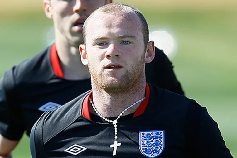 The U.S. soccer team will look shut down England's Wayne Rooney. (AP Photo/Kirsty Wigglesworth)