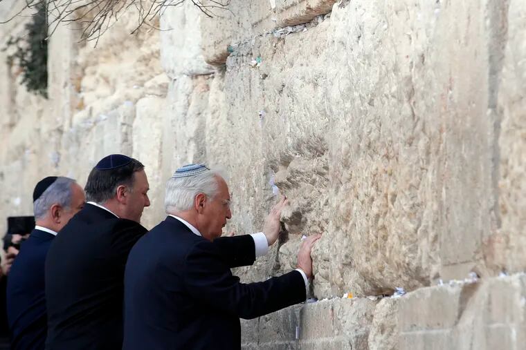 Israeli Prime Minister Benjamin Netanyahu, U.S. Secretary of State Mike Pompeo and U.S. Ambassador to Israel David Friedman touch the stones of the Western Wall during a visit to the site in Jerusalem's Old City, Thursday, March 21, 2019. (Jim Young/Pool Image via AP)