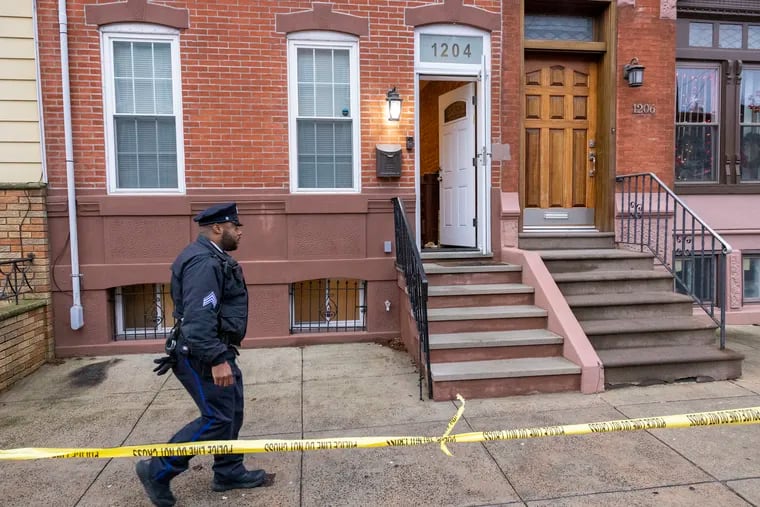 Philadelphia police hold the crime scene at rowhouse on 1200 block of Snyder Avenue on Dec. 23.