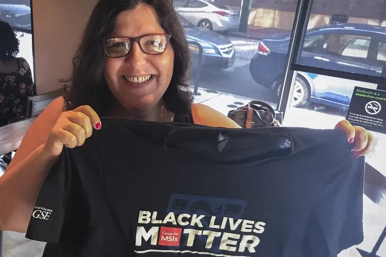 Marybeth Gasman of Philadelphia holds up the Black Lives Matter T-shirt she wore during a shopping trip to the Cherry Hill Mall.