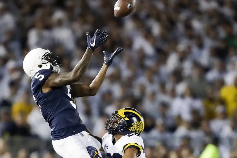 Penn State wide receiver DaeSean Hamilton leaps for a catch behind Michigan defensive back Tyree Kinnel.