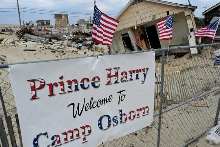 A sign is up in Camp Osborn, Brick Township, May 13, 2013 along the route Prince Harry is expected to take as visits Mantoloking and Seaside Heights on Tuesday. A fire burned some 60 homes in the area as Superstorm Sandy approached the coastline Oct. 29, and continued for at least two days. ( TOM GRALISH / Staff Photographer )
