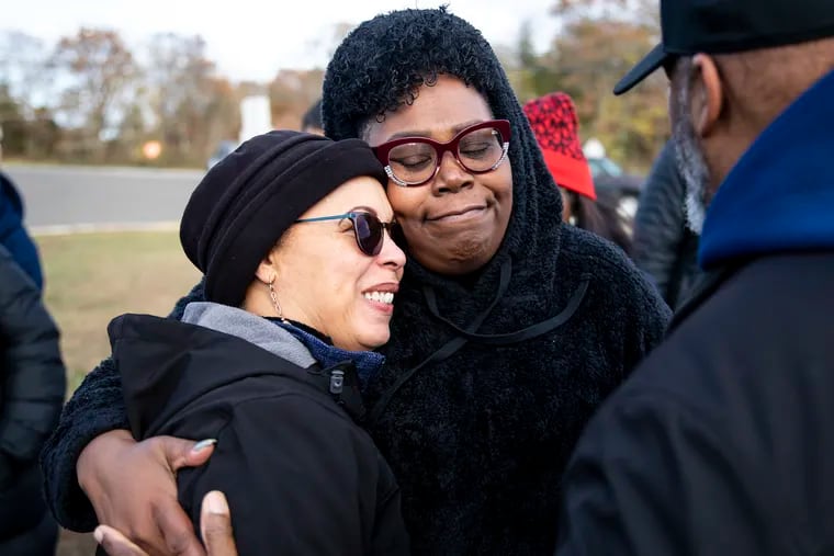 Lonniyell "The Community", 48, of Pleasantville, N.J., hugs Celeste Page, 58, of Atlantic City, N.J., school bus driver for Egg Harbor Township, during a vigil on Saturday.