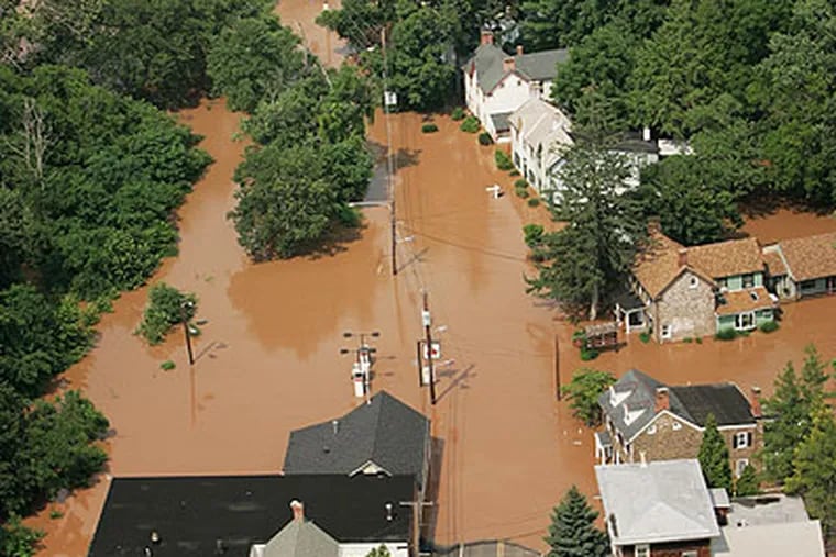 Could it happen again? Floodwaters reach into Yardley, Bucks County, after the Delaware River crested its banks on June 29, 2006. (Laurence Kesterson, File / Staff Photographer)