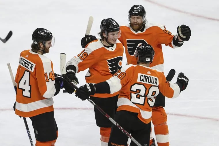Nolan Patrick (middle) celebrating what would be the game-winning goal against the Blue Jackets with teammates, clockwise from left Sean Couturier, Jake Voracek and Claude Giroux.