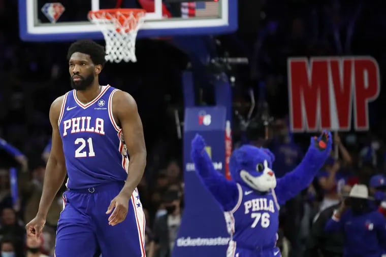 An MVP sign is seen behind Philadelphia 76ers center Joel Embiid (21) as he walks off after hitting a shot and a timeout is called by the Pelicans in the fourth quarter of a game at the Wells Fargo Center in South Philadelphia on Tuesday, Jan. 25, 2022. Sixers won, 117-107. Embiid finished with 42 points, 14 rebounds, and four blocks.