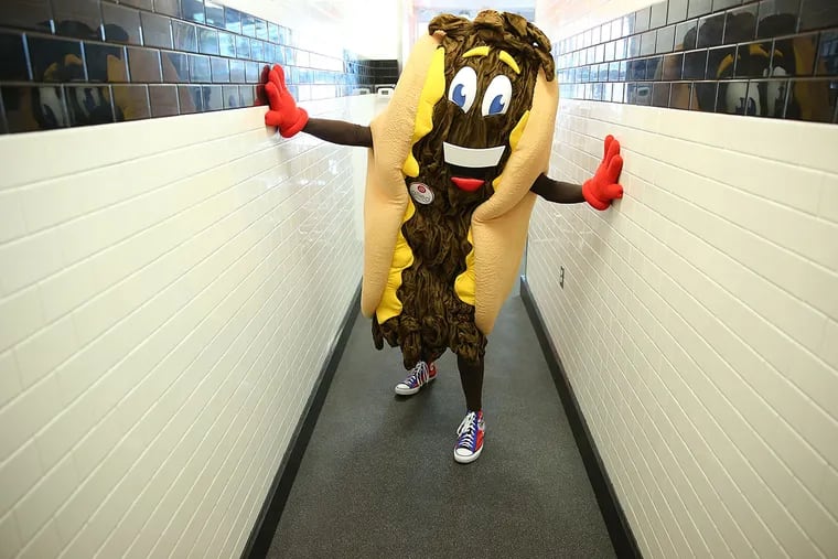 Cheesesteak Festival mascot "Cheesy" visits Steve Iliescu's Steve's Prince of Steaks at his Center City shop in Philadelphia on October 8, 2015.