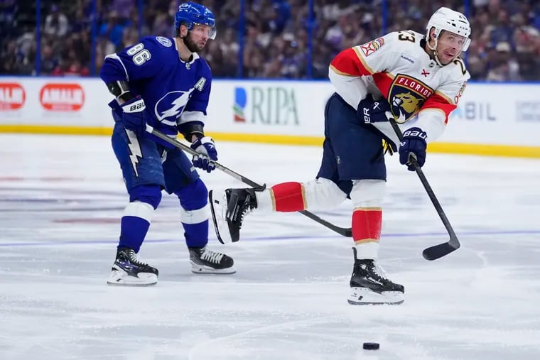 Carter Verhaeghe #23 of the Florida Panthers passes the puck against Nikita Kucherov #86 of the Tampa Bay Lightning during the third period of Game Four of the First Round of the 2024 Stanley Cup Playoffs at Amalie Arena on April 27, 2024 in Tampa, Florida.