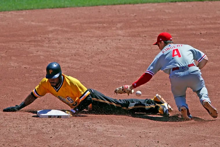 Phillies infielder Scott Kingery loses the ball trying to tag Pirates' outfielder Starling Marte stealing second.